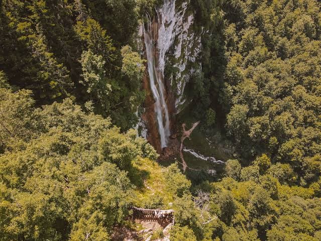 Skakavac waterfall falling through the beech forest above Sarajevo, viewing platform on the ridge
