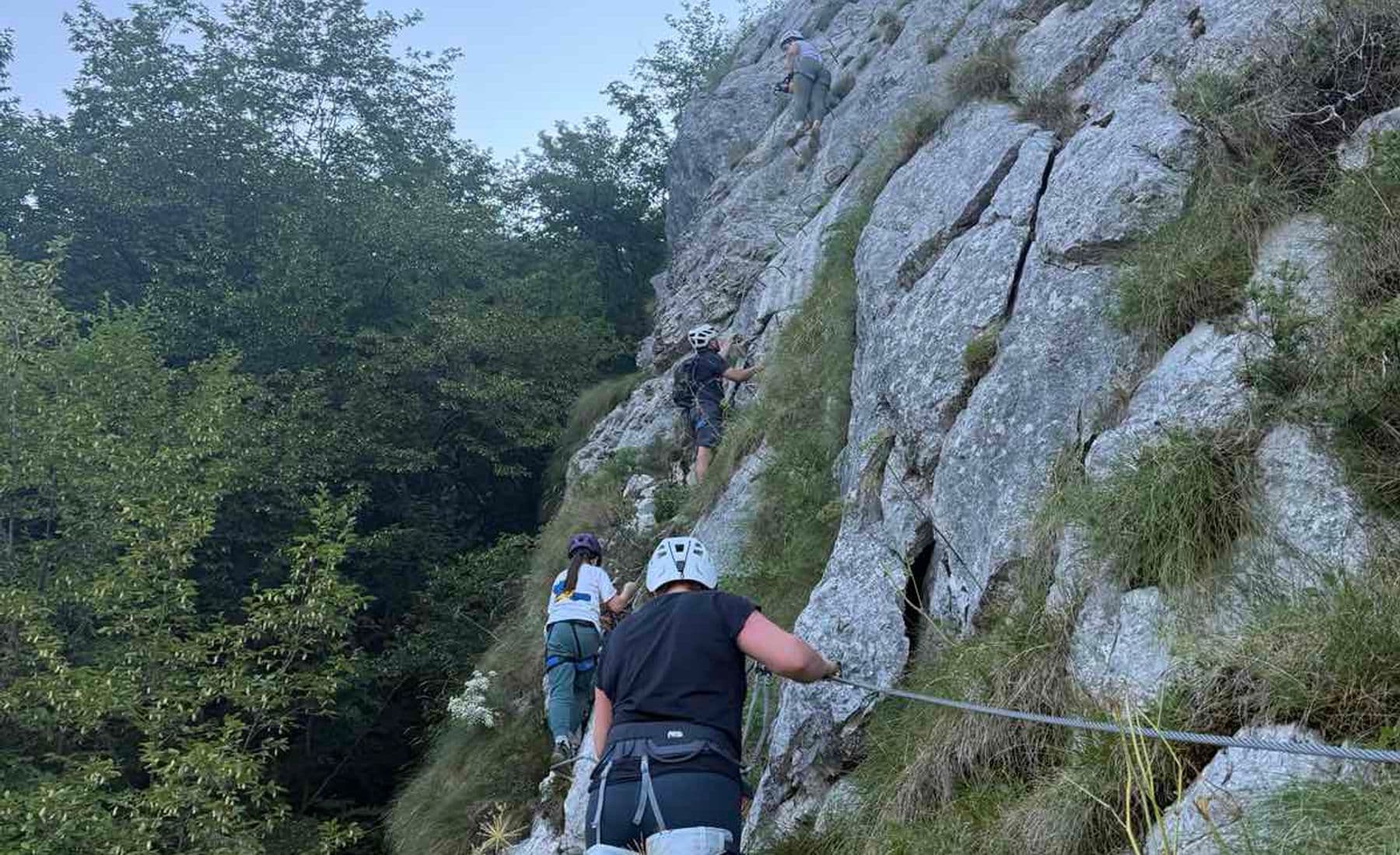 Group climbing the Bijela Stijena via ferrata at Bukovik near Sarajevo, beech forest alongside