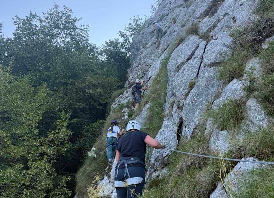 Group climbing the Bijela Stijena via ferrata at Bukovik near Sarajevo, beech forest alongside