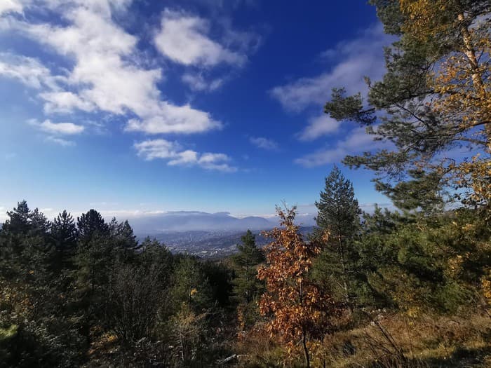 Autumn forest on the Čavljak–Bukovik trail looking out over the hazy Sarajevo valley