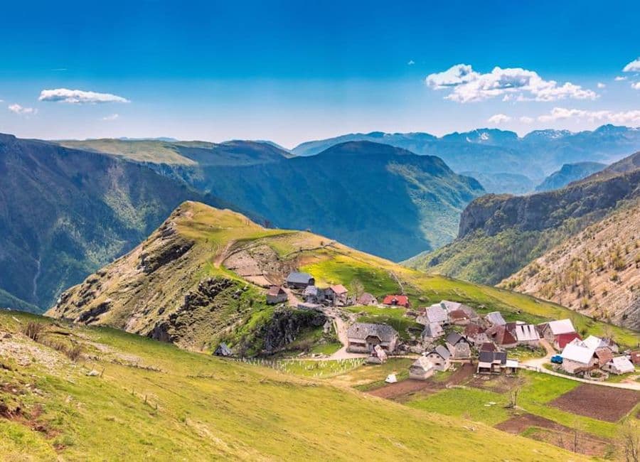 Highland meadows and the houses of Lukomir on the rim of the Rakitnica canyon, Bjelašnica
